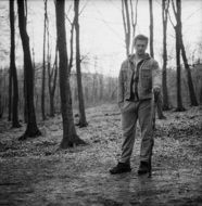 monochrome photo of young man in the forest