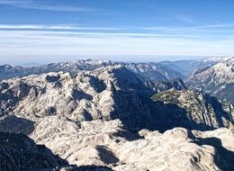 Beautiful panorama of cliffs in the alps under blue sky with white clouds on a sunny day