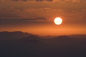 orange sun over the mountain range