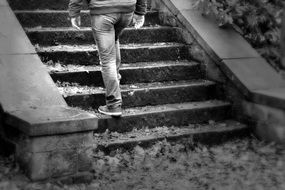 black and white photo of a man climbing stairs
