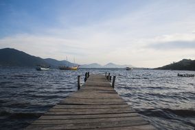 landscape of wooden pier on the ocean in Santa Catarina, Brazil