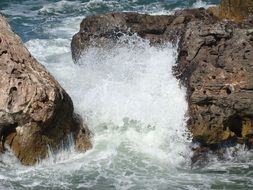 waves of water beat against the rocks