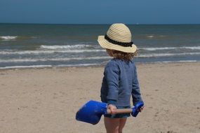 Resting child on a sand beach