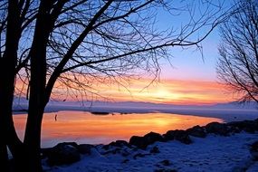 orange sunset reflected in the lake