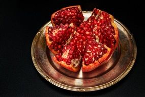 juicy pomegranate on a metal plate