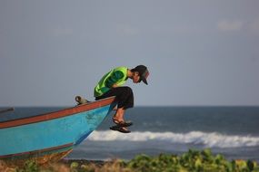Male sitting on a ship