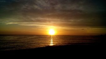 bright colorful evening sun on the horizon over the water