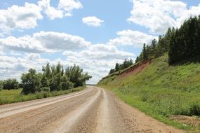 empty soil Road along hill side at summer, russia