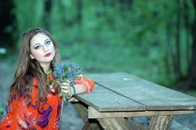 young woman sitting at the table alone