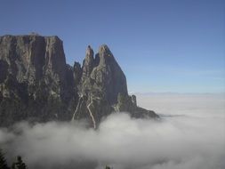 Schlern Mountain summit above clouds, italy, South Tyrol