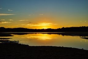 yellow sunset over a quiet lake