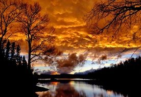 golden clouds over a lake in quebec at sunset