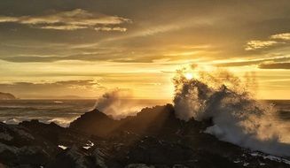 sunrise in the clouds over a winter beach