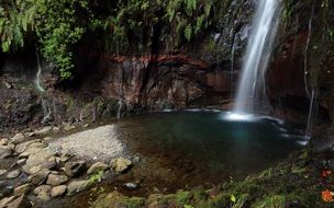 waterfall falls from a cliff