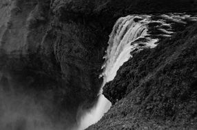 Waterfall on rock at wilderness, black and white