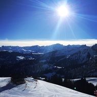 bright rising sun over snowy mountains