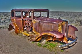 rusty antique american car on the side of highway 66