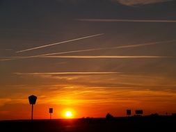 silhouettes of road signs on the highway at dusk