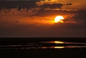 golden setting sun in the clouds
