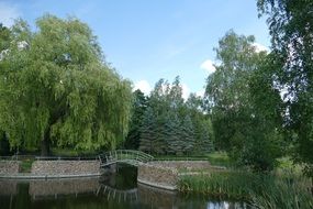 photo of a white bridge over a pond