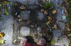 feet on a stone path in a park