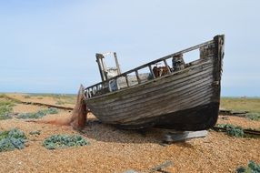 abandoned wooden boat on the coast