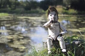 wooden doll by the lake close-up