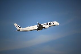 Aircraft of Finnair Flies in Blue Sky