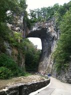 people on path in rocks under Natural Bridge, usa, Virginia