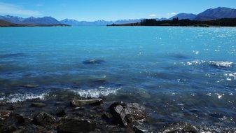 turquoise lake among mountains in new zealand