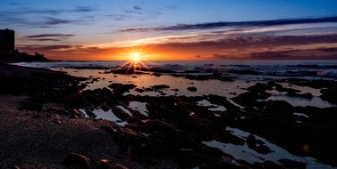 Horizon view of wonderful Dawn Clouds on Sky over the rocks on coast