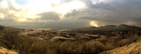landscape in the mountains under dark clouds