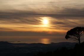 Landscape of lying sun over the ocean at dusk
