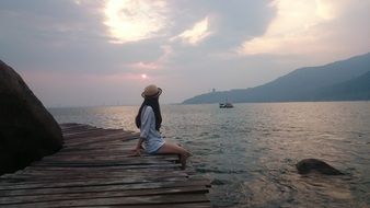 girl sitting on the beach near the sea