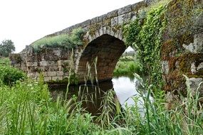 stone arch bridge over the river as a historical landmark