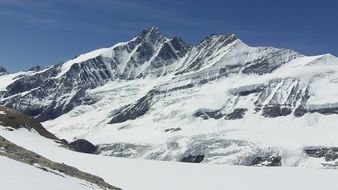 Snowy Alpine Mountains, summit at sky