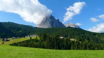 white clouds over mountains on a sunny day
