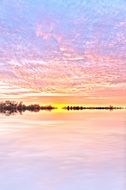 pink clouds reflected in water