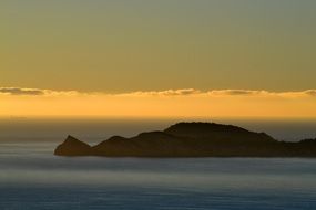 rocky Island in Sea at dusk, spain