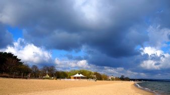 sky with low large clouds over a sandy beach