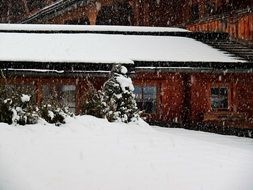 snow over a wooden house