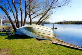 Boats upside down on grass in Park at Water