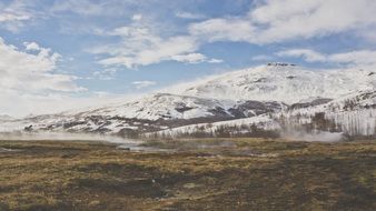 barren desert at the foot of snowy mountains