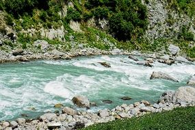 river among stones in the mountains of pakistan