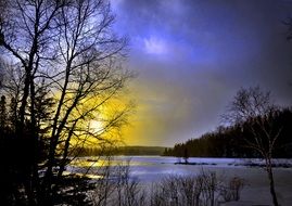 sunset over a lake in quebec in winter