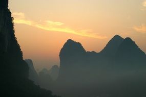 landscape of mountains silhouette in the sunrise sun