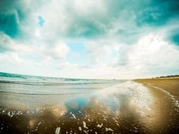 sky mirroring on sea at surfline, Italy