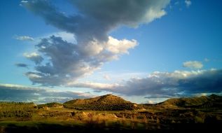 blue skies over mountains and field