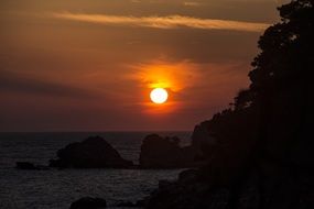 bright sun at sunset over the ocean coast