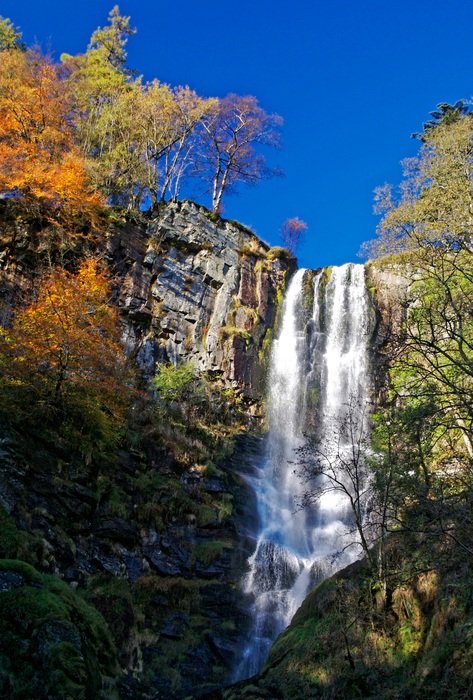 beautiful mountain waterfall in autumn